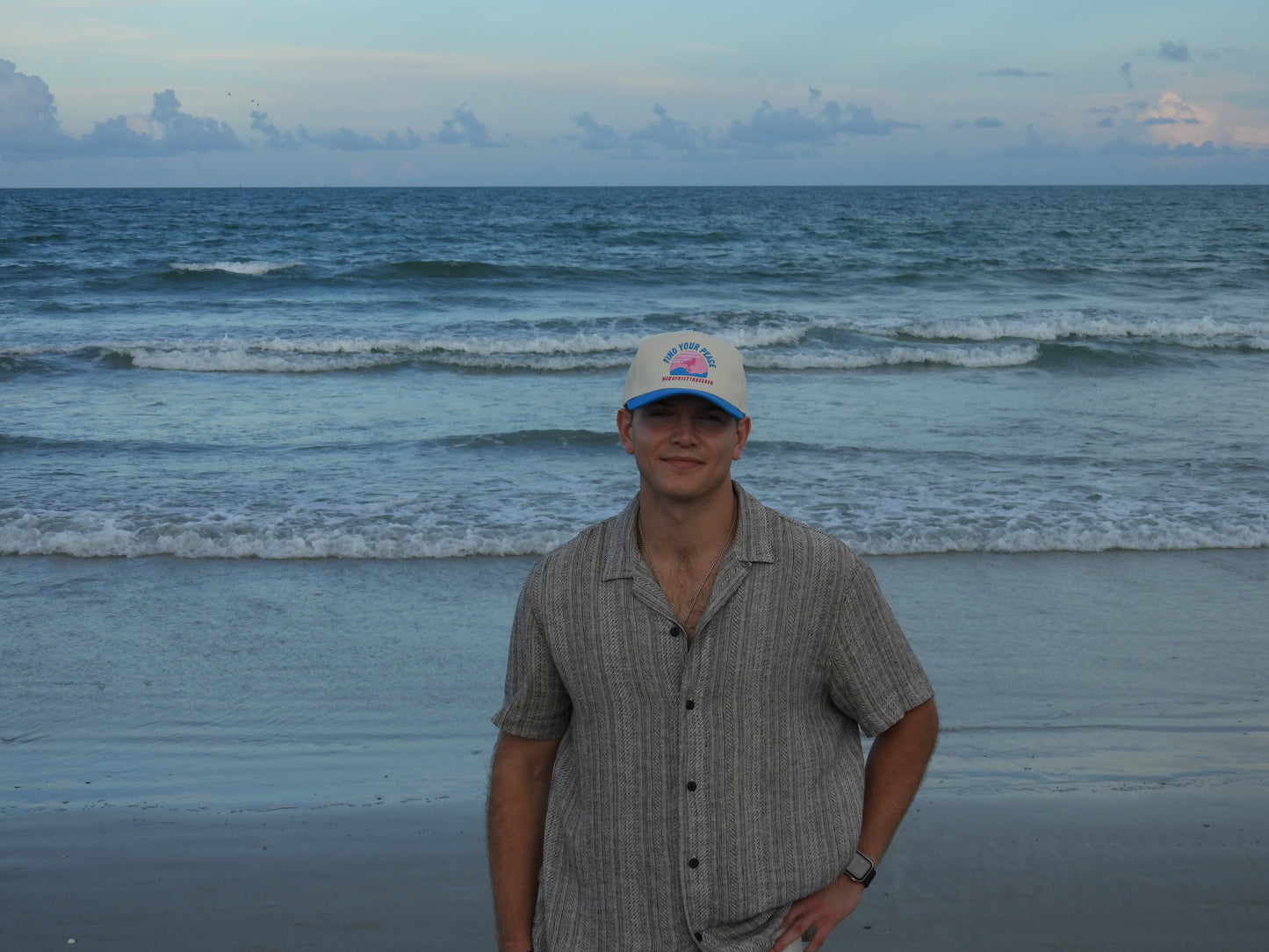 handsome guy on the beach wearing cool hat